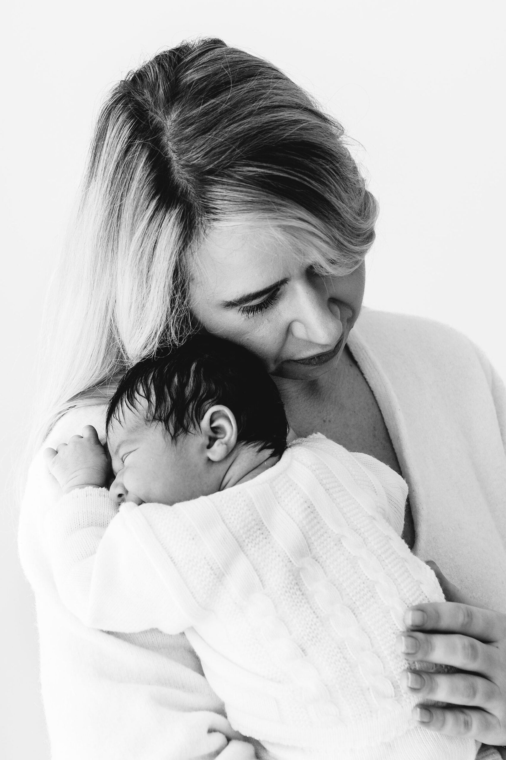 Sidcup newborn photoshoot- mum holding baby girl