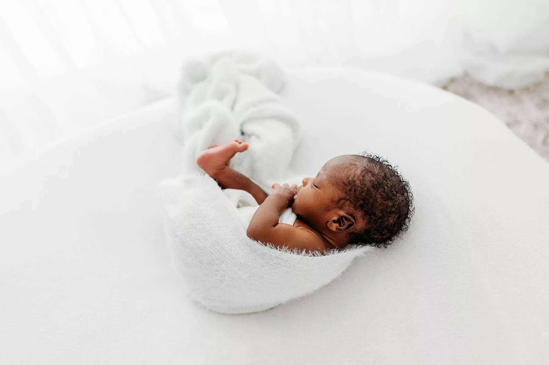 newborn photoshoot Kent- newborn baby on white blanket